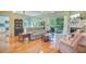 Bright living room with hardwood floors, fireplace, open to kitchen, and sliding doors to the outdoors at 5406 E Crosland Ct, North Charleston, SC 29420