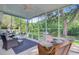 Relaxing screened porch with comfortable wicker furniture and a view of the lush backyard at 5406 E Crosland Ct, North Charleston, SC 29420