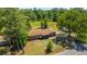Aerial view of a home with a brick exterior, well-manicured yard and inviting front porch at 565 Estates Dr, Walterboro, SC 29488