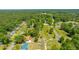 Aerial shot of a residential area with a dense forest backdrop and the neighborhood interspersed among the trees at 565 Estates Dr, Walterboro, SC 29488