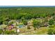 High-angle view of a suburban neighborhood adjacent to a green forest with assorted home styles and ample yards at 565 Estates Dr, Walterboro, SC 29488