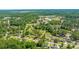 Aerial view displaying homes in a wooded area with nearby ball fields and community establishments at 565 Estates Dr, Walterboro, SC 29488
