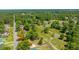 Aerial view showcases a charming neighborhood, surrounded by lush trees and a well-maintained road with parked cars at 565 Estates Dr, Walterboro, SC 29488