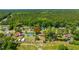 Aerial view of a suburban community, highlighting the diverse housing and verdant environment, adjacent to a lush forest at 565 Estates Dr, Walterboro, SC 29488