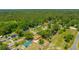 An overhead view of a peaceful residential community bordered by dense woods, showcasing a mix of home styles at 565 Estates Dr, Walterboro, SC 29488