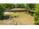 Aerial view of backyard with a cozy fire pit area and seating, showcasing the property's layout and setting at 565 Estates Dr, Walterboro, SC 29488