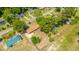 Aerial perspective of a charming home surrounded by lush trees, a maintained lawn, and a long driveway at 565 Estates Dr, Walterboro, SC 29488