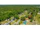 Scenic aerial view of a quiet neighborhood nestled among trees, featuring varied roof colors and well-kept properties at 565 Estates Dr, Walterboro, SC 29488