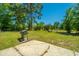 The backyard is large with grass and a small concrete slab, including a grill at 565 Estates Dr, Walterboro, SC 29488