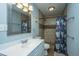 Well-lit bathroom featuring a sink, toilet, and shower with decorative curtain at 565 Estates Dr, Walterboro, SC 29488