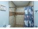 Clean and stylish bathroom featuring tiled walls, a shower with a curtain, and modern fixtures at 565 Estates Dr, Walterboro, SC 29488