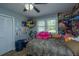 Bright bedroom features wood flooring, ceiling fan and window at 565 Estates Dr, Walterboro, SC 29488