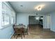 A view of the dining area boasting wood flooring, a wooden table, and natural light from a nearby window at 565 Estates Dr, Walterboro, SC 29488