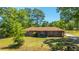 Charming brick home featuring a well-manicured lawn and inviting front porch sitting area at 565 Estates Dr, Walterboro, SC 29488
