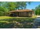 Charming brick home with a well-maintained yard, inviting front porch, and classic architectural details at 565 Estates Dr, Walterboro, SC 29488