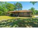 Charming brick ranch-style home with a covered front porch and a well-maintained yard at 565 Estates Dr, Walterboro, SC 29488