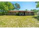 Charming brick home with a welcoming front porch, lush landscaping, and a well-maintained lawn at 565 Estates Dr, Walterboro, SC 29488