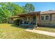 Inviting front porch with comfortable seating, a 'Relax' sign, and a quaint rug, creating a cozy entrance at 565 Estates Dr, Walterboro, SC 29488