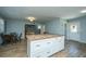 Bright kitchen island with a butcher block countertop and white cabinetry is open to the dining area at 565 Estates Dr, Walterboro, SC 29488