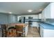 Open concept kitchen with a kitchen island and seating, stainless steel appliances, and bright lighting at 565 Estates Dr, Walterboro, SC 29488