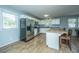 Modern kitchen with a stainless steel refrigerator, kitchen island, and lots of natural light coming through the windows at 565 Estates Dr, Walterboro, SC 29488