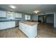 The kitchen features white cabinetry, stainless steel appliances, a center island, and an open floorplan at 565 Estates Dr, Walterboro, SC 29488
