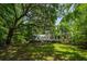Charming backyard with a lush lawn and mature trees, perfect for outdoor living and relaxation at 6 Sayle Rd, Charleston, SC 29407