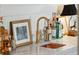Close up of bar area features copper sink, marble countertop, brass faucet, and glassware at 6 Sayle Rd, Charleston, SC 29407