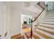 Bright foyer with stairs leading up and a view into the living room with a fireplace and light-filled windows at 6 Sayle Rd, Charleston, SC 29407