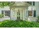Inviting front porch with classic white columns and manicured greenery at 6 Sayle Rd, Charleston, SC 29407