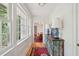 Bright hallway with large windows features hardwood floors and antique blue chest at 6 Sayle Rd, Charleston, SC 29407