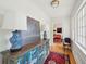 Hallway features hardwood floors, antique chest, and view into adjoining living room at 6 Sayle Rd, Charleston, SC 29407