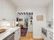 Bright kitchen with white cabinets, stainless steel appliances, hardwood floors, and view to the living room at 6 Sayle Rd, Charleston, SC 29407