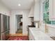 Kitchen with stainless steel appliances, gold faucet, white marble countertops, and a view to the yard at 6 Sayle Rd, Charleston, SC 29407