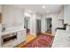 Spacious, well-lit kitchen with white cabinets, stainless steel appliances, and hardwood floors with a red Persian rug at 6 Sayle Rd, Charleston, SC 29407