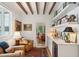 Inviting living room features beamed ceilings, stylish bar with a wine fridge, and hardwood floors at 6 Sayle Rd, Charleston, SC 29407