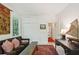 View of the living room showcasing a comfortable couch, decorative rug, and a charming sailboat decoration at 6 Sayle Rd, Charleston, SC 29407