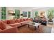 Bright living room featuring stylish sofa, large windows, and hardwood floors at 6 Sayle Rd, Charleston, SC 29407