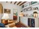 Inviting living room features beamed ceilings, stylish bar with a wine fridge, and hardwood floors at 6 Sayle Rd, Charleston, SC 29407