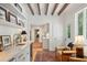 Inviting living room features beamed ceilings, stylish bar with a wine fridge, and hardwood floors at 6 Sayle Rd, Charleston, SC 29407