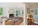 Bright living room featuring a fireplace, hardwood floors, and a cozy seating area at 6 Sayle Rd, Charleston, SC 29407