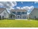 Expansive backyard showcasing the house, screened porch, and outdoor patio at 602 Yellow Leaf Ln, Summerville, SC 29486