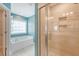 Bright bathroom featuring a soaking tub, tiled shower, and natural light from window at 602 Yellow Leaf Ln, Summerville, SC 29486