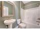 Bathroom showcasing a pedestal sink, updated fixtures, and a tub-shower combo at 602 Yellow Leaf Ln, Summerville, SC 29486