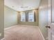 Comfortable bedroom with neutral carpeting, ceiling fan, and natural light from two windows at 602 Yellow Leaf Ln, Summerville, SC 29486