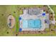 Overhead view of a lovely pool area with ample lounge chairs and lush tropical landscaping at 602 Yellow Leaf Ln, Summerville, SC 29486