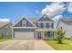 Beautiful two-story home with blue siding, a two-car garage, and a lovely front yard with landscaping at 602 Yellow Leaf Ln, Summerville, SC 29486
