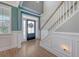 Elegant foyer featuring a staircase, beautiful paneling, and natural light from the front door at 602 Yellow Leaf Ln, Summerville, SC 29486