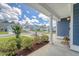 Covered front porch showcasing landscaped yard and neighborhood views at 602 Yellow Leaf Ln, Summerville, SC 29486