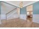 Elegant living room featuring wainscoting, hardwood floors, a staircase and a view of the modern kitchen at 602 Yellow Leaf Ln, Summerville, SC 29486